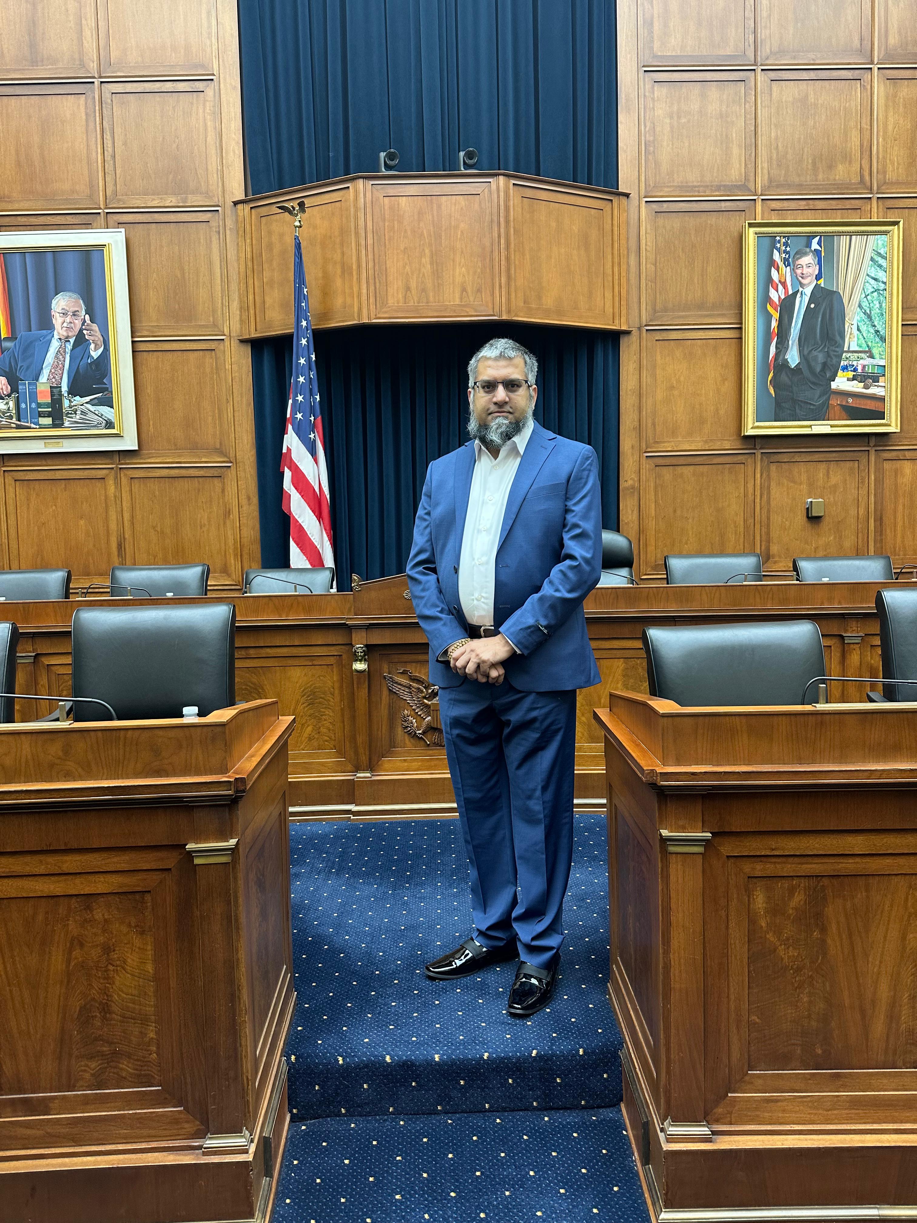 Dr. Zeeshan-ul-Hassan Usmani standing at a national institution, representing leadership in AI, data science, and ethical technology research